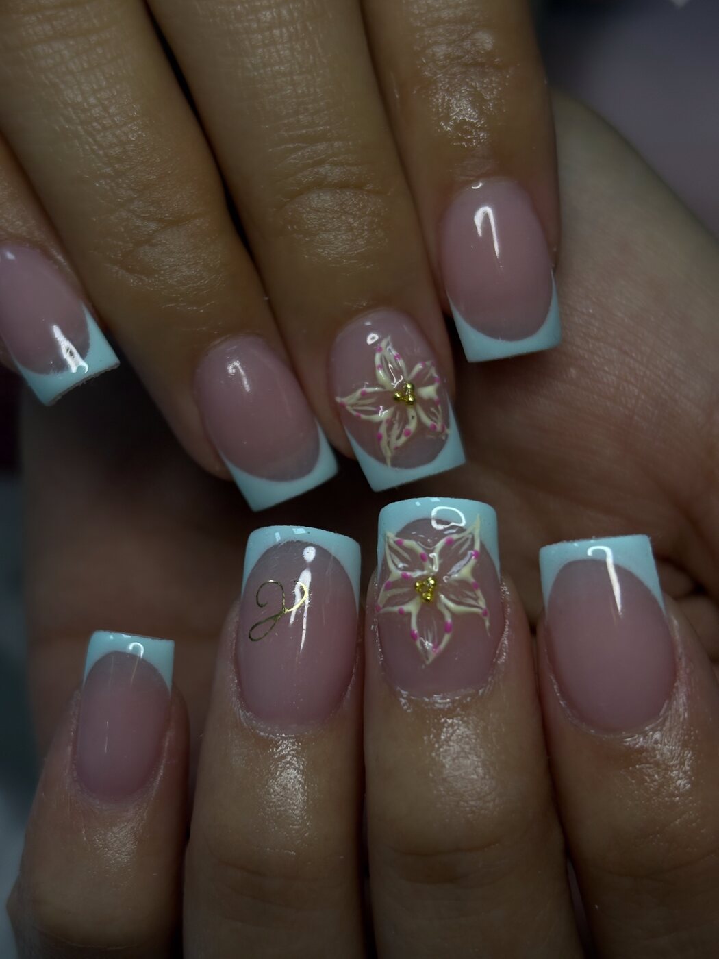 Short mint French tips with a hand-painted lily